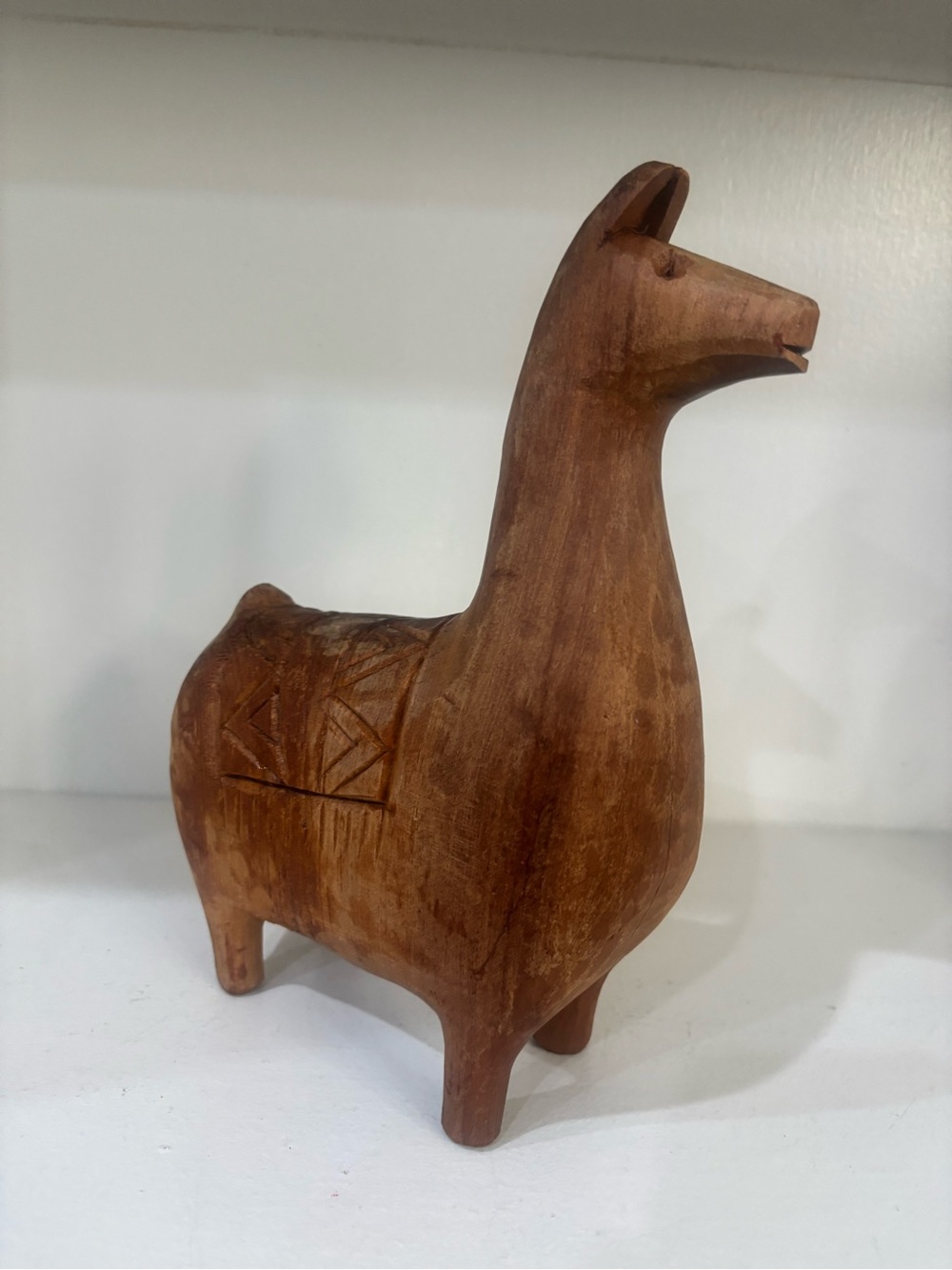 Wood carved llama figurine